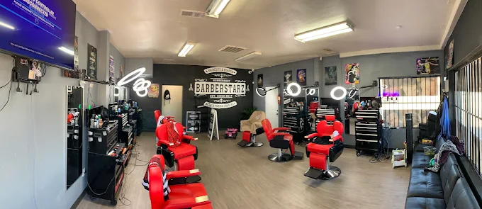 Inside BarberStarz Barbershop Tulare and Chestnut with red barber chairs and ring lights
