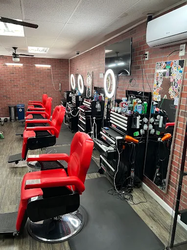 Red barber chairs and stations inside BarberStarz Barbershop Clinton and Chestnut